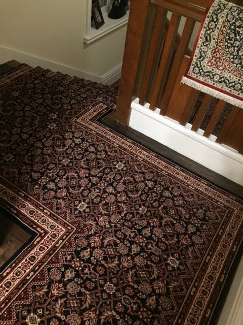 Patterned stair runner carpet on landing