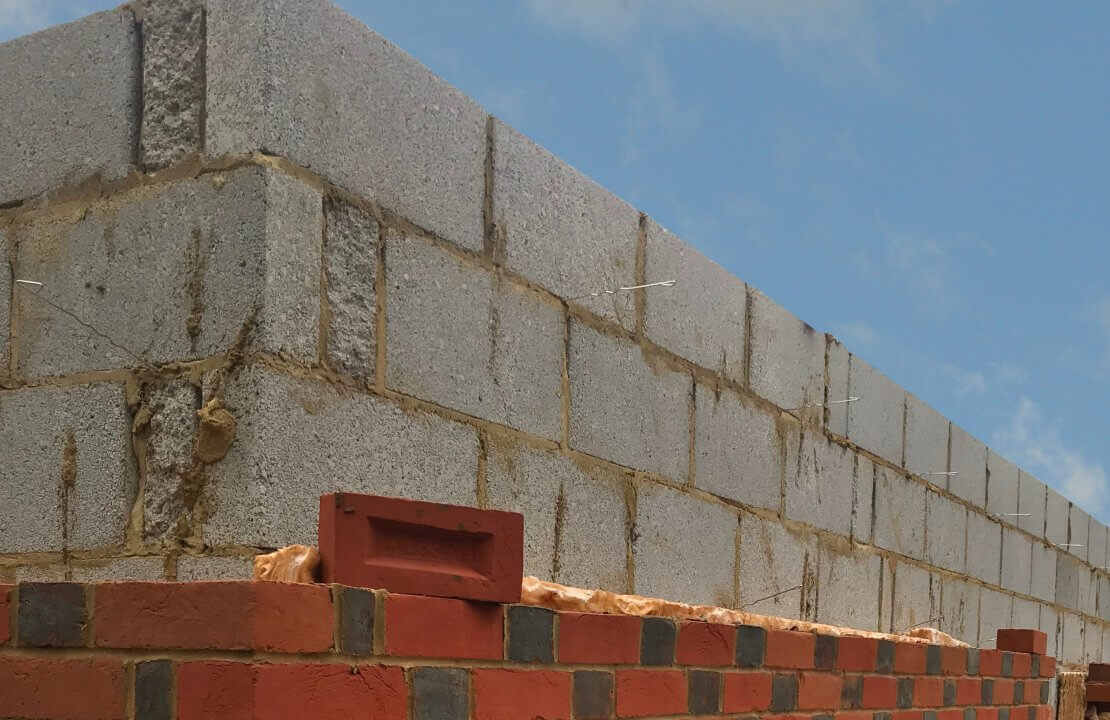 Can you use imperial size bricks with metric blocks when building a new cavity wall?