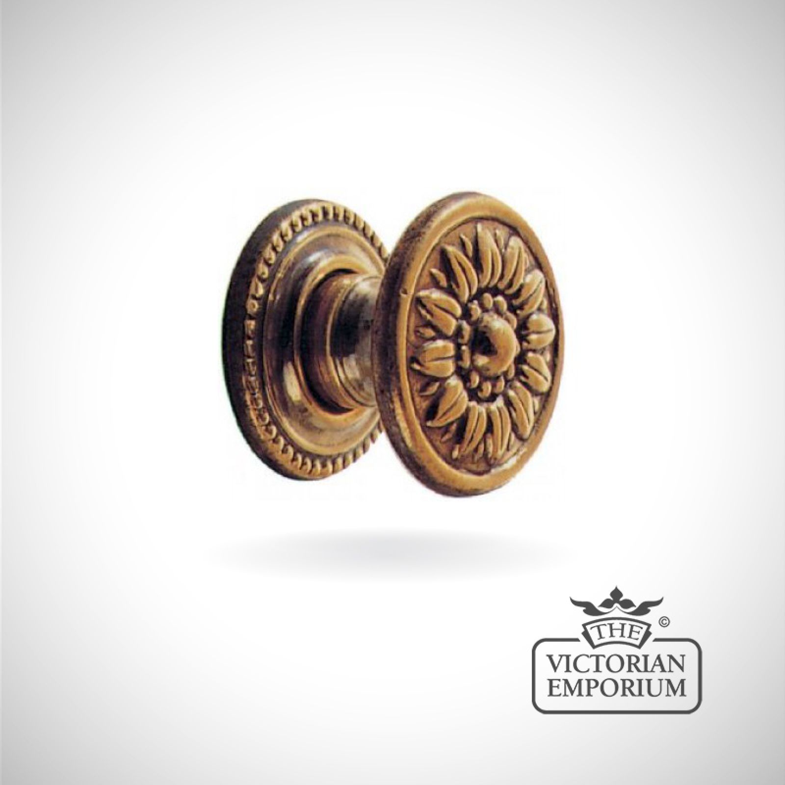 Decorative cupboard knob with flower pattern in antique brass