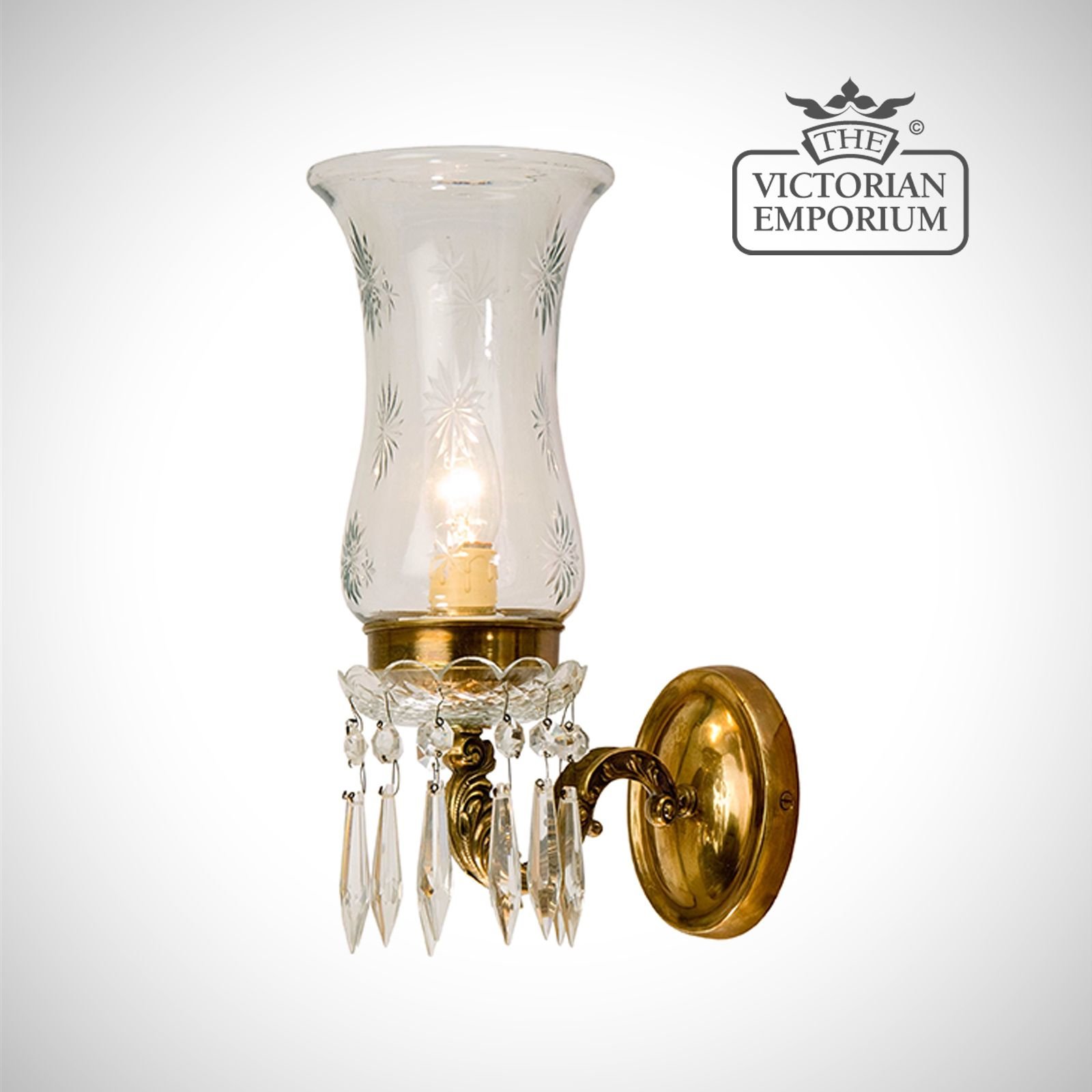 Wall sconce with a cut glass shade