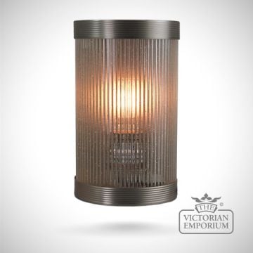 Small reeded glass wall sconce in antique bronze