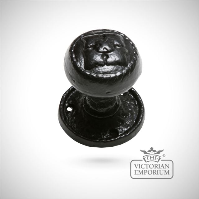 Black iron handcrafted door knob on circular plate