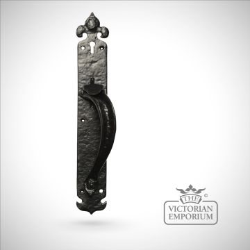 Black iron handcrafted door handle on plain rectangular plate
