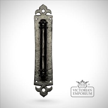 Black iron handcrafted door handle on plain rectangular plate