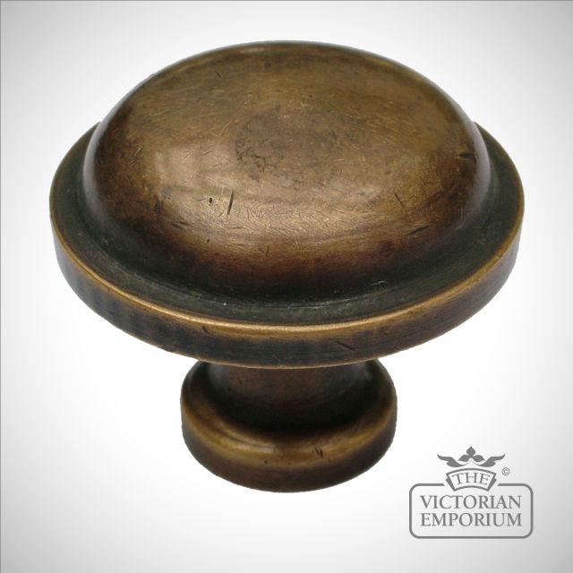 Brass button cabinet knob in antique brass